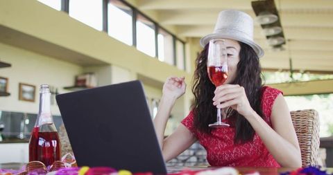 Joyful woman celebrating new year with online call