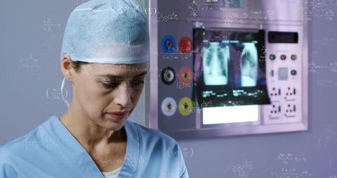 Female Surgical Technician Monitoring X-ray Panels and Medical Equipment for Diagnostics