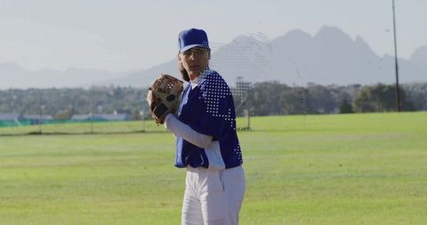 Female baseball player preparing to pitch ball