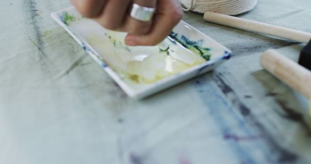 Artist's Hand Mixing Paints on Palette in Studio - Download Free Stock Images Pikwizard.com