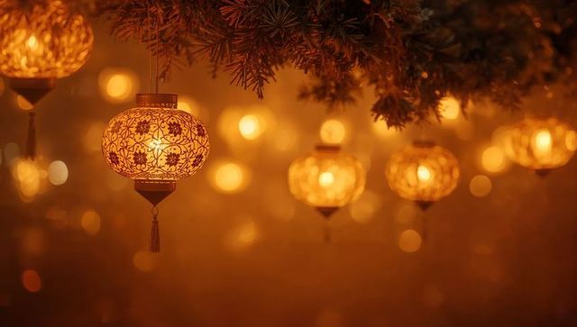 Hanging ornate filigree lanterns casting warm amber glow under evergreen boughs
