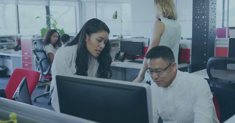Collaborative Office Team Analyzing Data on Computer
