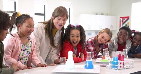 Diverse Children Curiously Watching Science Experiment in Classroom