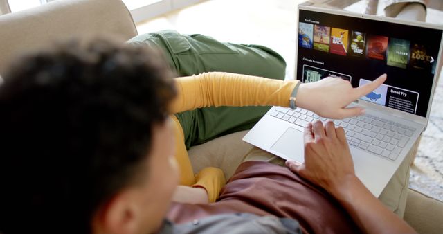 Friends Choosing Movie on Laptop in Living Room - Download Free Stock Images Pikwizard.com