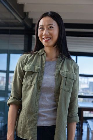 Confident Asian Woman in Modern Office Environment