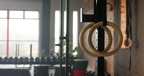 Wooden gymnastic rings in modern industrial gym