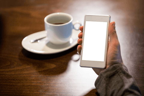 Transparent background smartphone mockup in cafeteria setting