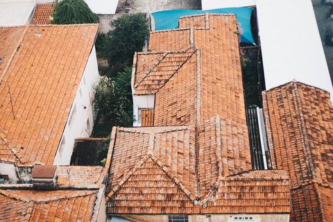 Aerial pattern of weathered terracotta rooftops in tight urban neighborhood