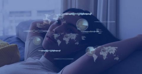 Reclining man gazing at camera with holographic world maps and digital data overlays