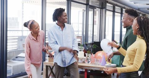 Team Celebrating Office Birthday with Cake and Joyful Interaction