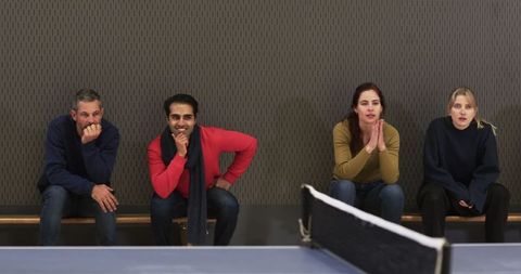 Diverse Friends Watching Intense Table Tennis Match with Enthusiasm