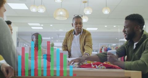 Diverse team collaborating in office with interactive data visualization