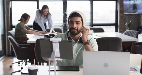 Young Professional Conducting Video Conference in Modern Workspace - Download Free Stock Images Pikwizard.com