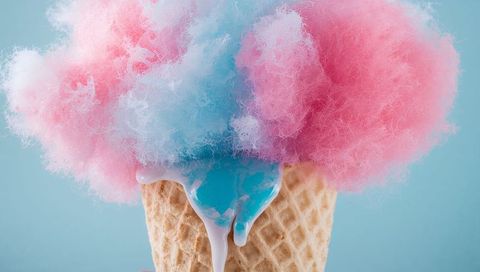 Melting cotton candy cone with dripping pastel blue and pink syrup, closeup still life