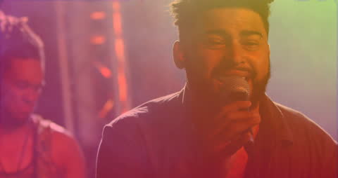 Energetic Singer Performing with Vibrant Light Effects