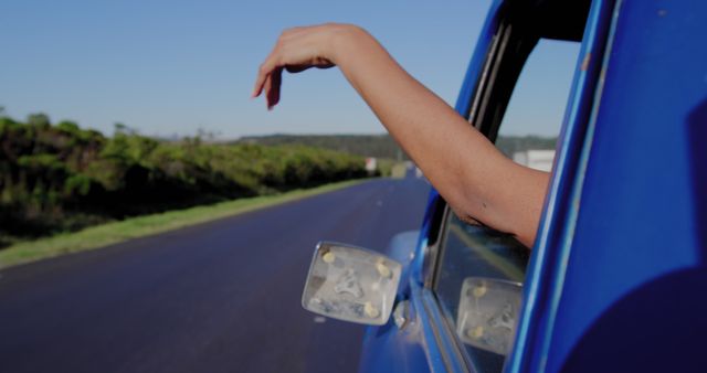 Relaxed Hand Hanging out Car Window on Sunny Day Road Trip - Download Free Stock Images Pikwizard.com