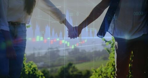 Couple Holding Hands on Coastal Bluff with Candlestick Charts Overlay Symbolizing Investment