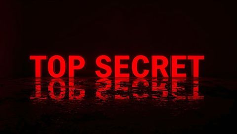 Glowing red top secret neon letters reflecting on glossy dark floor cinematic