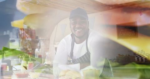 Smiling Chef Grilling Burgers at Food Truck