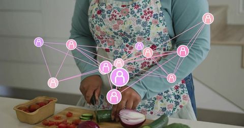 Chopping vegetables in floral apron with pink social network overlay connecting community