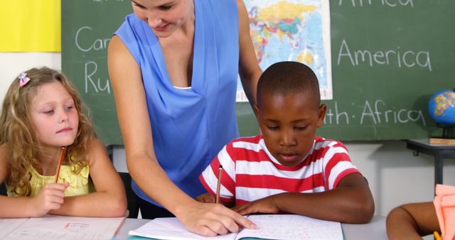 Teacher Helping Students in Classroom with Homework - Download Free Stock Images Pikwizard.com