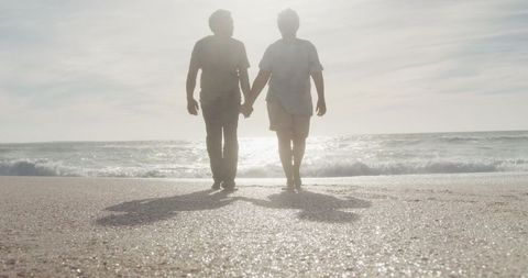 Couple Enjoying Romantic Sunset Walk on Beach
