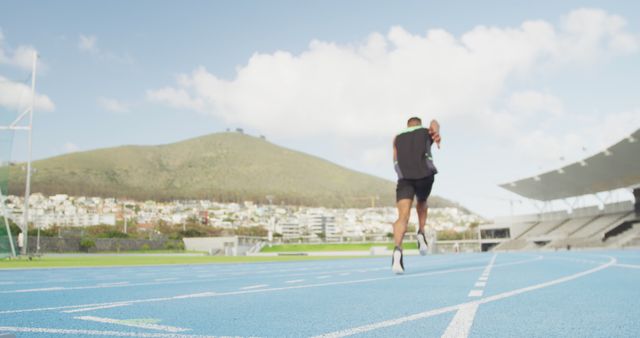 Male Runner Sprinting on Track with Scenic Mountain View - Download Free Stock Images Pikwizard.com