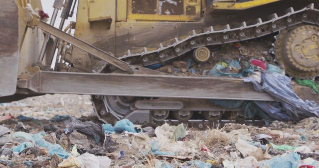 Close up of landfill with piles of litter and dozer. Landfill, waste, pollution and environment.