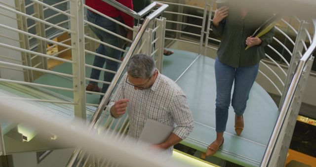 Employees Descending Office Staircase with Documents - Download Free Stock Images Pikwizard.com