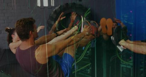 Group Engaged in Leg Raises for Core Workout at Gym