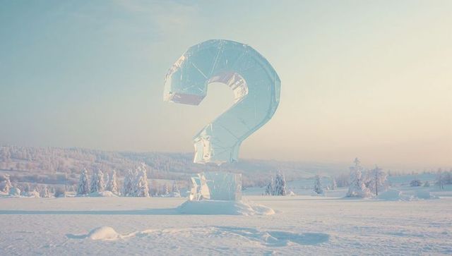 Glistening ice question mark sculpture in serene winter landscape