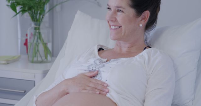 Smiling Pregnant Woman in Hospital Bed Awaiting Birth - Download Free Stock Images Pikwizard.com