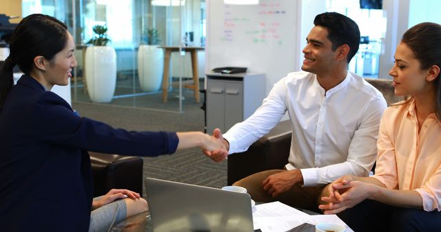 Diverse Business Team Shaking Hands During Meeting in Modern Office - Download Free Stock Images Pikwizard.com