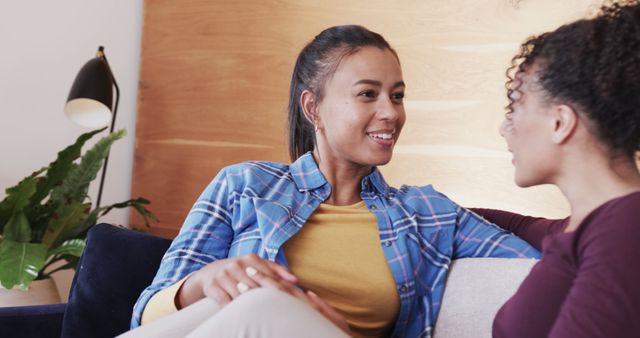 Two Multiethnic Women Relaxing on Couch Engaging in Friendly Conversation - Download Free Stock Images Pikwizard.com