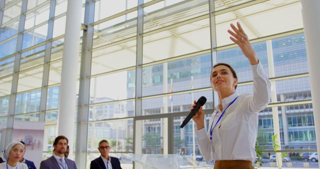 Front view of a Caucasian female speaker speaking in a microphone in a business seminar 4k
