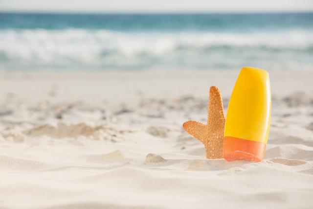 Bottle of sunscreen lotion and starfish kept on sand - Download Free Stock Photos Pikwizard.com