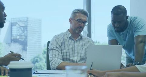Diverse Team Executives Collaborating on Project in Modern Office