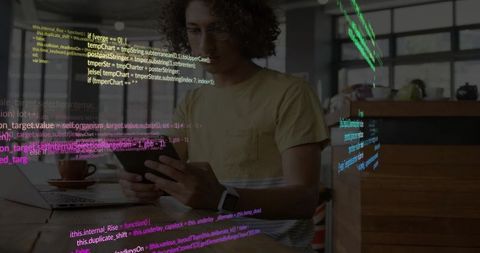 Adult programmer debugging on tablet in cafe coworking space with colorful code overlays