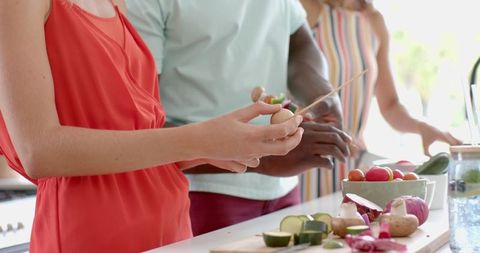 Diverse Friends Cooking Healthy Meal in Modern Kitchen