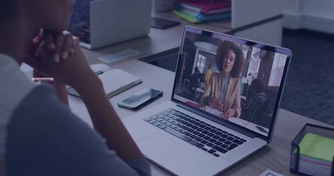 Business Professional in Online Team Meeting at Office Desk