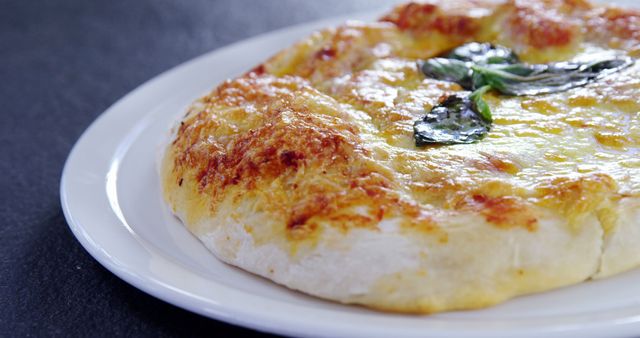 This close-up image of a freshly baked Margherita pizza showcases the golden crust with melted cheese and fresh basil leaves, making it perfect for representing Italian cuisine, homemade cooking, or comfort food themes on restaurant menus, food blogs, cooking websites, or social media posts.