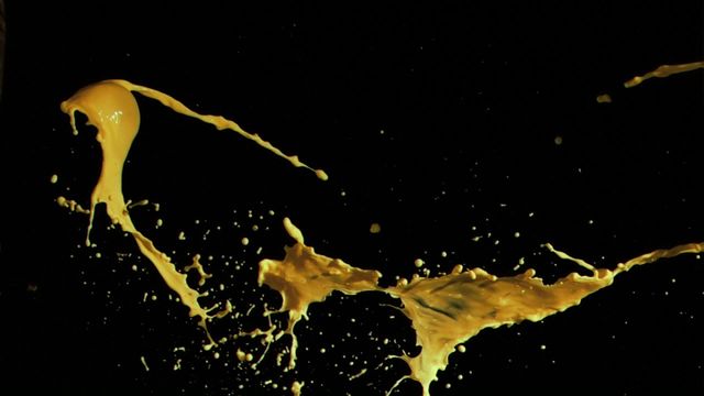 Vibrant splash of yellow paint creating dynamic motion against deep black. Ideal for artistic and abstract projects, design inspirations, contrasting effects, or highlighting creative concepts and ideas.