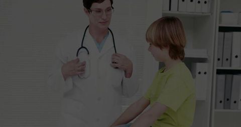 Pediatrician consulting young patient in modern clinic