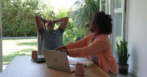 Young Couple Relaxing with Laptop and Coffee at Home