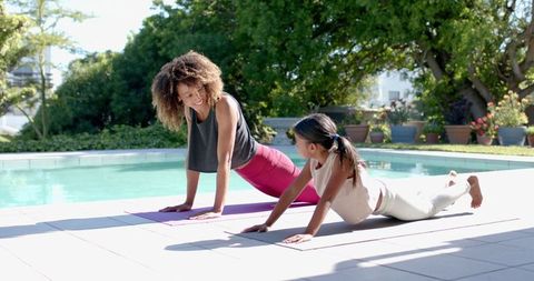 Mother and Daughter Practicing Yoga by Poolside - Download Free Stock Images Pikwizard.com