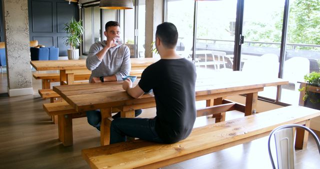 Two Men Meeting in Modern Cafe Over Coffee - Download Free Stock Images Pikwizard.com