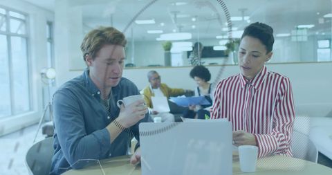 Collaborating Team in Modern Office with Digital Interface Overlay