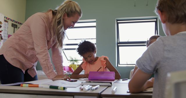 Teacher Helping Diverse Students with Classwork in Modern Classroom - Download Free Stock Images Pikwizard.com