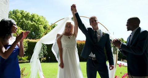 Just Married Couple Celebrating with Guests in Garden Ceremony