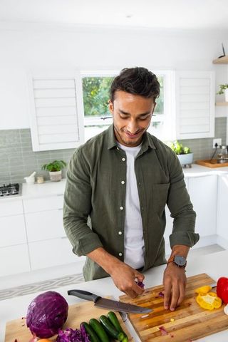 Indian Man Preparing Fresh Vegetables in Contemporary Kitchen